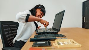 Lady Tech repairing a computer